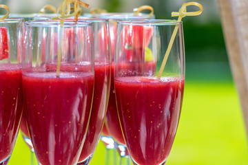 watermellon gazpacho juice in glass cups with green background