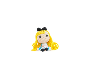 Cute crochet doll. A cute crochet doll with blond hair and apron isolated on a white background.