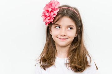 Little caucasian girl with costume and accessories having fun