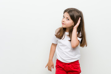 Little caucasian girl trying to listening a gossip.