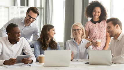 Cheerful multiracial office workers having fun at break in workplace