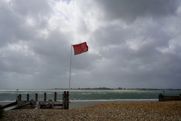 Red warning flag on a beach