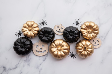 Obraz na płótnie Canvas Halloween luxury gold and black pumpkin flat lay background composition