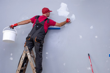 House Painting Business, Tradesman painting a wall