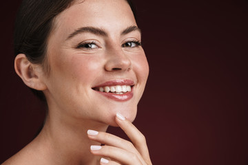 Image of teenage shirtless woman with clean fresh face smiling at camera