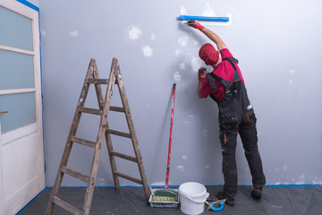 House Painting Business, Tradesman painting a wall