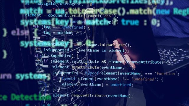 Programming code is coming up above the man typing on the laptop