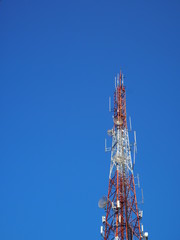 Transmission tower. Telephone pole, old telephone, cut against the sky.