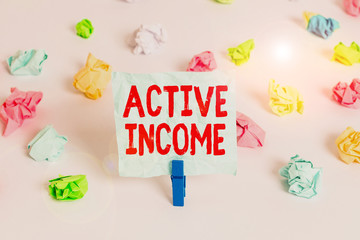 Handwriting text Active Income. Conceptual photo Royalties Salaries Pensions Financial Investments Tips Colored crumpled papers empty reminder white floor background clothespin