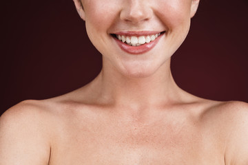 Cropped image of pretty shirtless woman smiling at camera