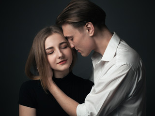 Young couple in love posing in studio