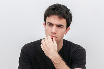 pensive young man on white background