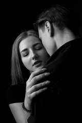 Portrait of passionate young couple in love. Low key. Black and white
