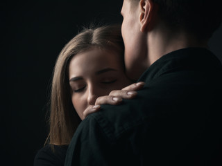 Portrait of passionate young couple in love. Close up. Low key