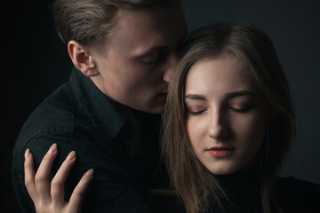 Portrait of passionate young couple in love. Close up.
