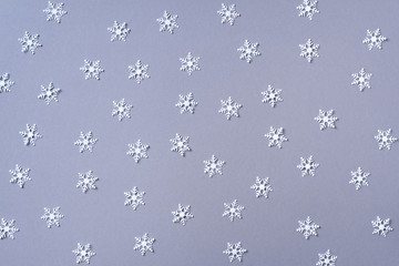 Winter composition. Christmas, new year concept. Top view. Flat lay. Winter pattern made of white snowflakes on grey background.