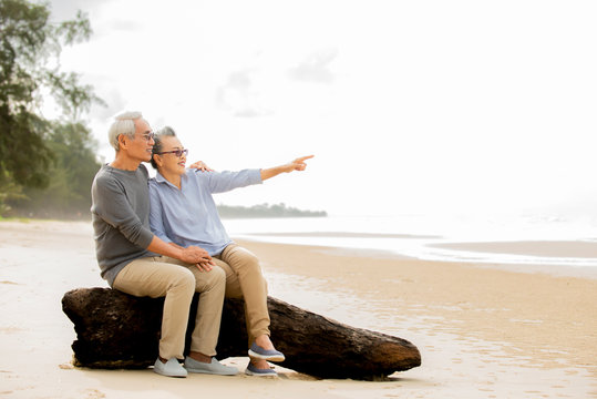 Relax  Asian Senior Couple  Sitting  Have Fun And Enjoy At The Beach, ,Retirement Lifestyle Healthy  Travel Vacation Concept