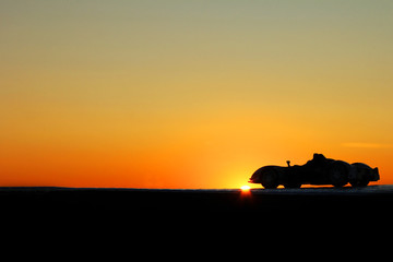 Fototapeta premium Car on a sunset background. Beautiful landscape. Car in the shade