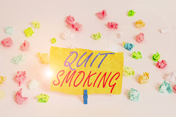 Fototapeta na wymiar Word writing text Quit Smoking. Business photo showcasing process of discontinuing tobacco smoking or cessation Colored crumpled papers empty reminder white floor background clothespin