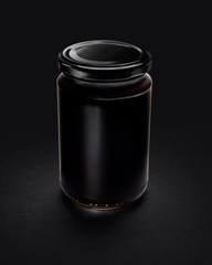 Canned glass jar filled with a dark fluid