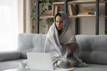 Sick woman feel cold at home covered with blanket