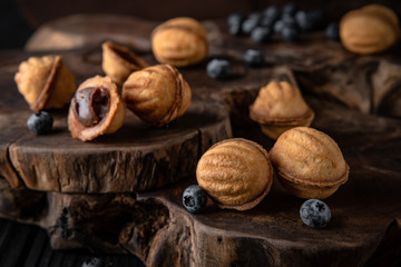 Crispy and crumbly delicious cookies Condensed Milk Nuts  with natural ingredients: flour, nuts, seeds, pieces of chocolate, cocoa, fruit jams. Stylish still life for poster.