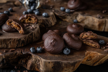 Chocolate biscuit. Crispy and crumbly delicious cookies with natural ingredients: flour, nuts, seeds, pieces of chocolate, cocoa, fruit jams. Beautiful wallpaper. Stylish still life for poster.