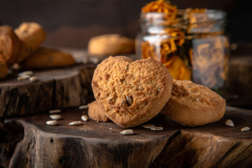 Biscuit with berry or fruit filling. Crispy and crumbly delicious cookies with natural ingredients: flour, nuts, seeds, pieces of chocolate, cocoa, fruit jams.   Stylish still life for poster.