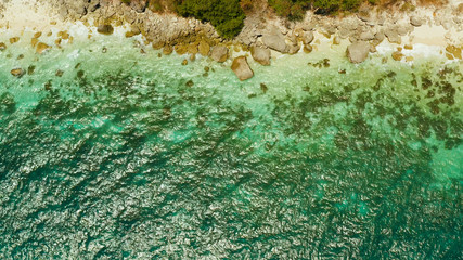 Travel concept: sandy beach and azure water of the lagoon from above,copy space for text. Ocean with waves and tropical beach. Summer and travel vacation concept