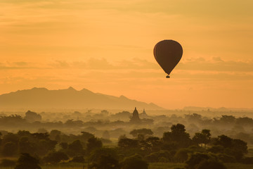 Sunrise over Bagan with Ballon at a foggy sky, Myanmar temples in the Archaeological Park