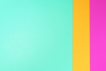 Obraz premium Background in trendy green, pink and yellow colors. Fashionable paper. Top view. Minimal concept. Trendy mint color