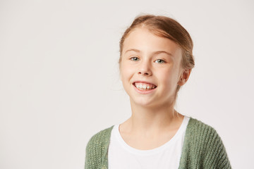 Portrait of happy little girl smiling at camera isolated on white background