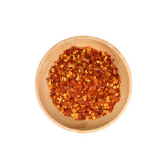 Dried red chili pepper flakes in wooden bowl isolate on white background