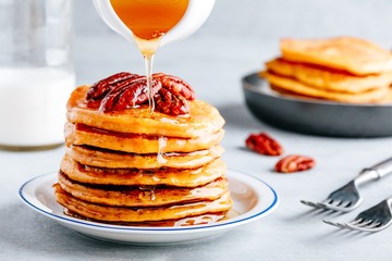 Pumpkin pancakes with pecans and maple syrup or honey