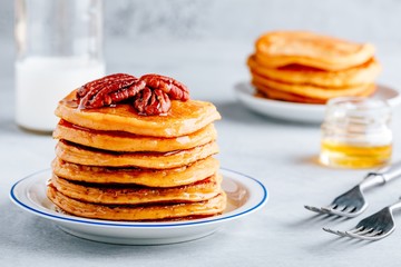 Pumpkin pancakes with pecans and maple syrup or honey