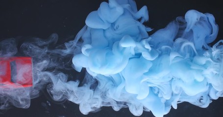 Red toy car leaving blue smoke trail, macro shot