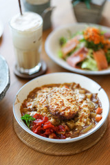 Hamburg rice. A closed up details of Japanese curry hamburg rice topping with grilled cheese with soft focus.