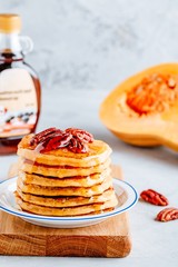 Pumpkin pancakes with pecans and maple syrup or honey