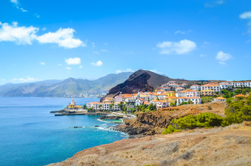 Beautiful Marina da Quinta Grande in Madeira island, Portugal. Small village, harbour located by Ponta de Sao Lourenco. Rocks and hills behind the city by the Atlantic ocean. Cityscape. Travel places