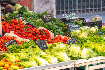 Fresh fruits and vegetables at farmers' market: lettuce, tomatoes and other