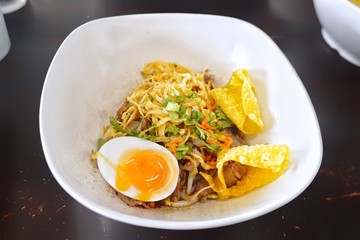 Spicy noodle with pork and boiled egg.
