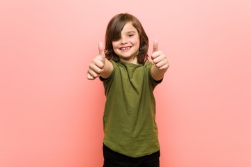 Little boy with thumbs ups, cheers about something, support and respect concept.