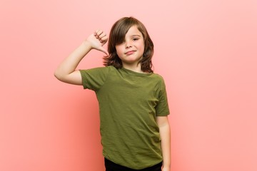 Little boy showing a dislike gesture, thumbs down. Disagreement concept.