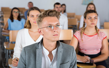 Young man listening to lecture