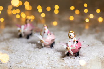 A set of decorative Christmas-themed statuettes. Santa claus deer and snowman in pink airplanes...