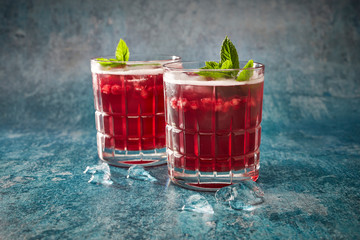 Elderberry cordial with ice and mint in glass close up