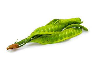 Closeup image of asian bitter green beans known as twisted cluster bean isolated at white...