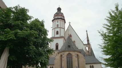 St. Thomas Church (Thomaskirche) in Leipzig, Germany, Europe. Remains of Johann Sebastian Bach are here. 4K Background Panning Low Angle Shot