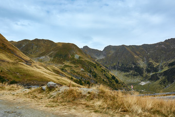 View of Transfagarash highway and valley in mountains of Romania. Tourist view mountain road. Autumn mountain landscape.