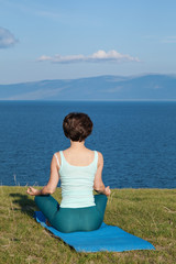 Fototapeta na wymiar Woman Yoga. Woman practice meditation at the coast